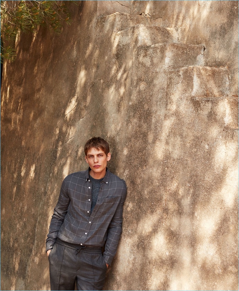 Clad in gray, Baptiste Radufe wears a Saturdays NYC shirt with a Valentino sweater and Brioni trousers.