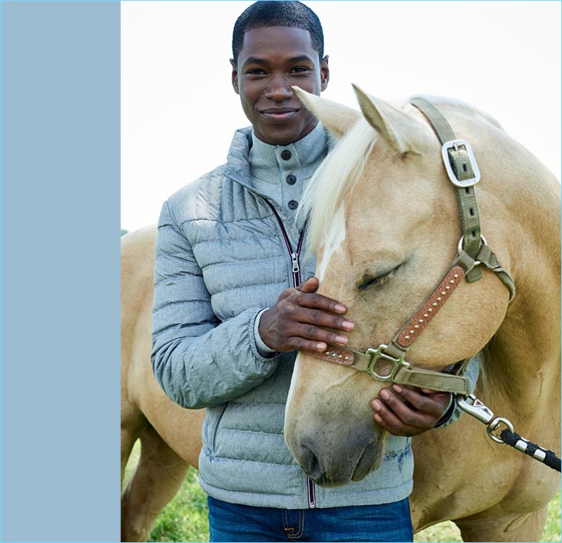 Starring in a Macy's style edit, Ronald Epps wears a Tommy Hilfiger packable puffer jacket.