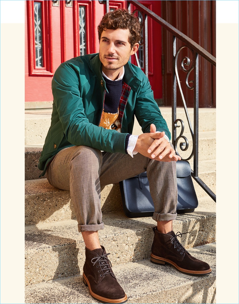 The Harrington Jacket: Baracuta's G9 Harrington jacket makes an appearance in green. East Dane styles it with a Maison Kitsune fox head sweater and Lacoste oxford shirt. David Kitz also wears A.P.C. pants and Rag & Bone chukka boots.