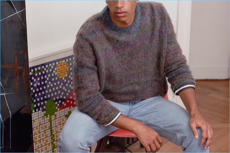 Nothing says cozy like this oversize mélange knit sweater by Acne Studios. A casual element is added with Stella McCartney denim jeans and a Margaret Howell striped t-shirt.