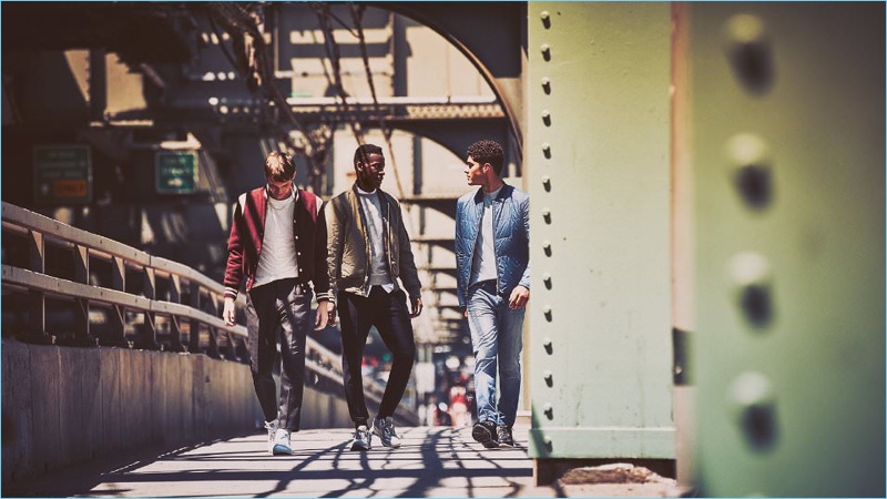 Boys in the City (Left to Right): Rocky Harwood wears a Golden Bear bomber jacket with a Dries Van Noten t-shirt, Acne Studios trousers, and Adidas Originals sneakers. David Agbodji models an Engineered Garments bomber jacket with a Thom Browne sweatshirt and Acne Studios shirt. His look is complete with Wooyoungmi sweatpants and Lanvin sneakers. Torin Verdone sports a Maison Margiela quilted jacket with a Lanvin t-shirt, Saint Laurent jeans, and Lanvin sneakers.