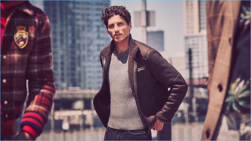 American model Ryan Kennedy wears a Loro Piana leather-trimmed shearling jacket with a ribbed Tom Ford sweater, and Berluti jeans.