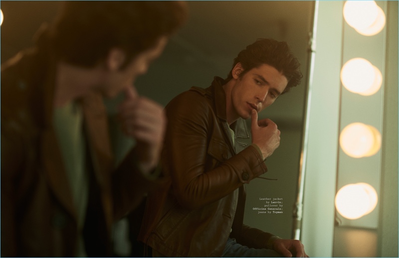 Looking at his reflection, Pico Alexander wears a Lanvin leather jacket with an Officine Generale pullover and Topman jeans.