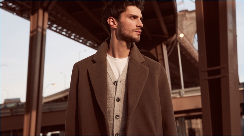 Matthew Bell dons a Reiss cashmere blend overcoat $660 with a cardigan $220 and t-shirt $50.