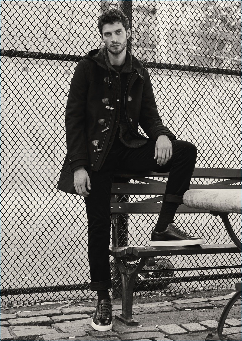 Standing tall, Matthew Bell wears a Reiss dufflecoat $660 with slim-fit chinos $210 and leather sneakers $255.