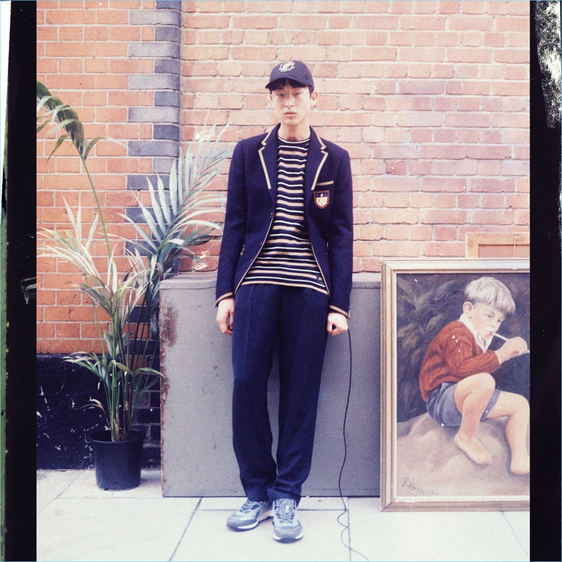 Going for a preppy look, Sang Woo Kim sports a Gucci blazer and Stella McCartney striped t-shirt. He also wears Raey trousers and a Dolce & Gabbana cap.