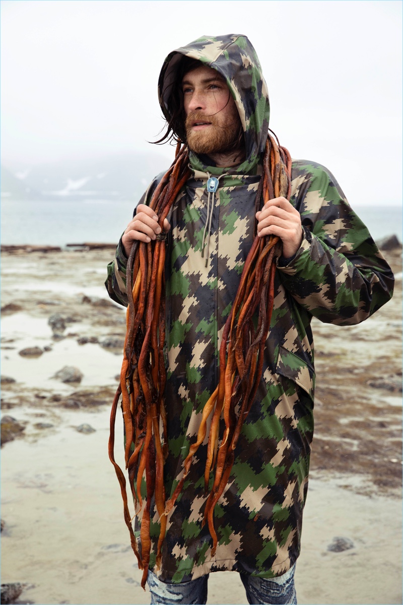 Model Calin Sitar wears a camouflage print parka from Scotch & Soda.