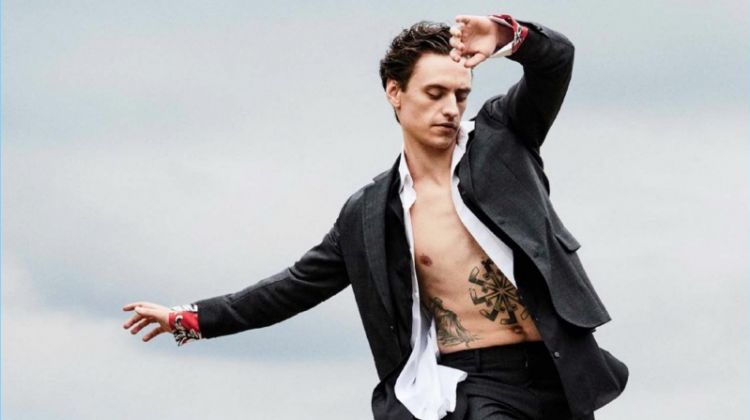 Striking a pose, Sergei Polunin dons a Salvatore Ferragamo suit with a J.W. Anderson shirt. Polunin layers with a Charvet shirt and wears Dries Van Noten shoes.