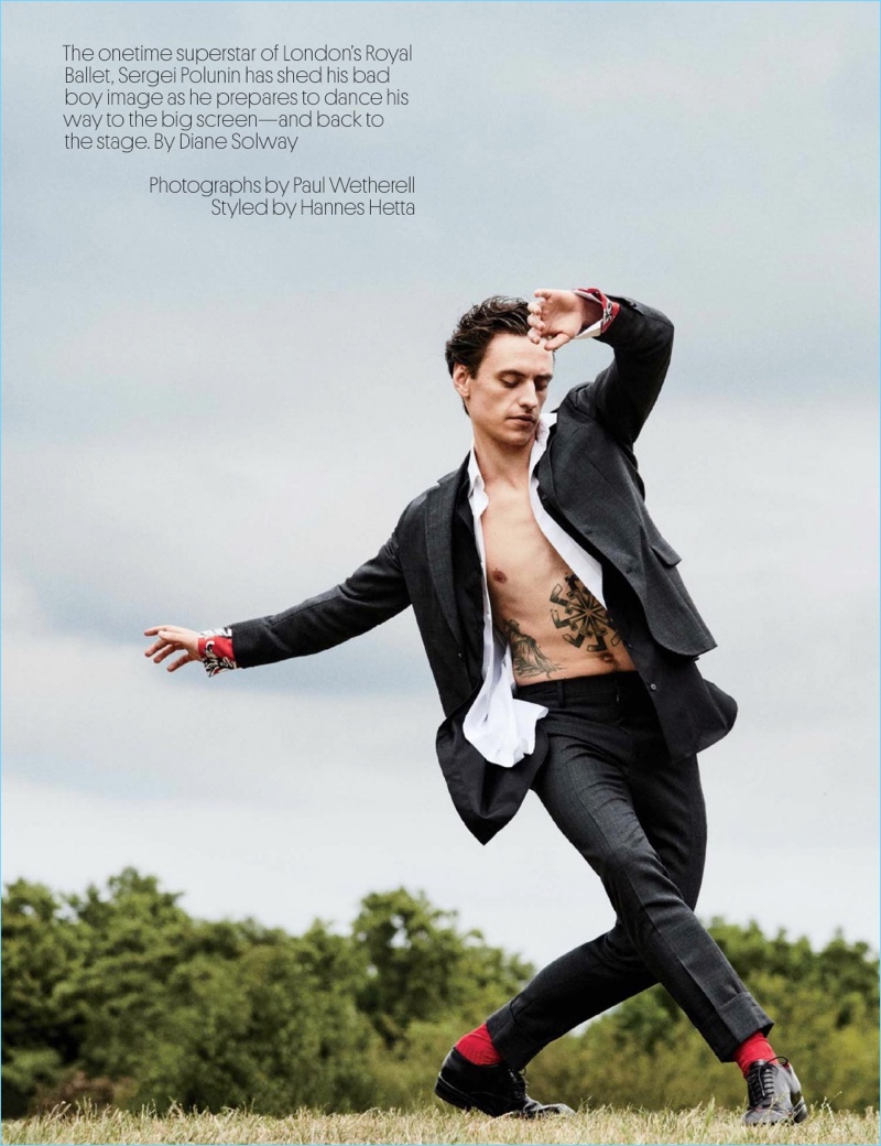 Striking a pose, Sergei Polunin dons a  Salvatore Ferragamo suit with a J.W. Anderson shirt. Polunin layers with a Charvet shirt and wears Dries Van Noten shoes.