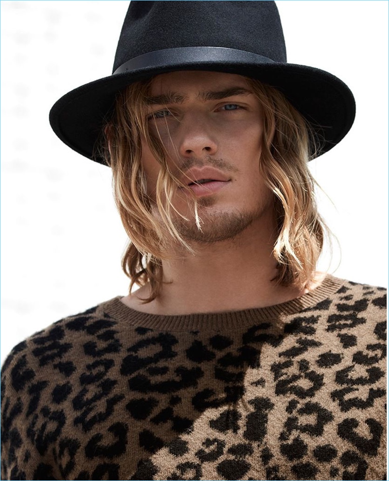 A rock 'n' roll vision, Ton Heukels wears a LE 31 leopard print sweater with a Brixton hat.