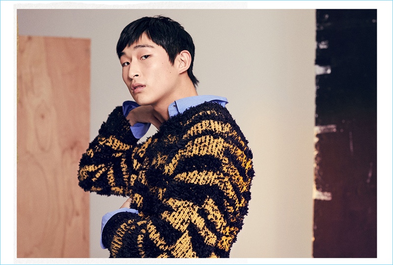 Making a texture play, Sang Woo Kim wears a Stella McCartney striped sweater and shirt.