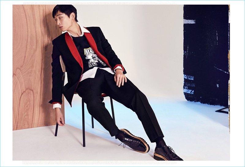 A sharp but playful vision, Sang Woo Kim wears a Stella McCartney tuxedo jacket with a graphic t-shirt. The Korean model also sports Stella McCartney trousers and shoes.