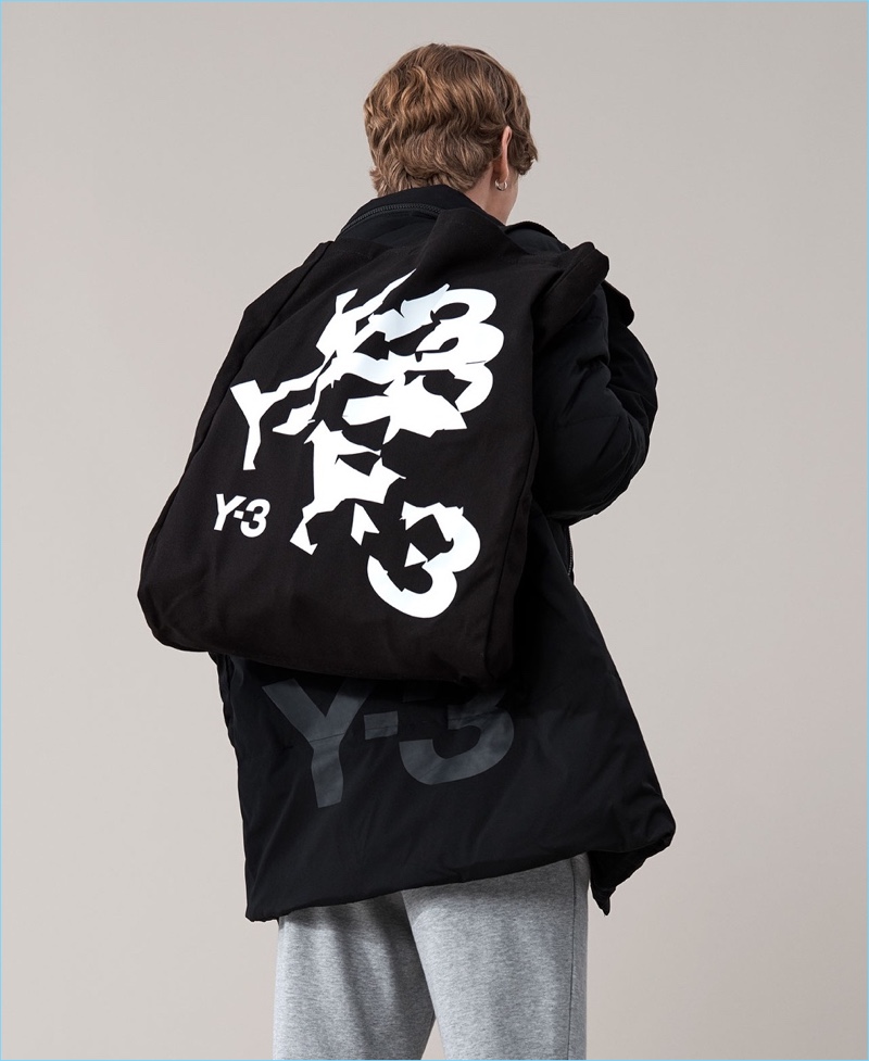 Connecting with Matches Fashion, Robbi G. rocks a Y-3 quilted jacket, track pants, and logo print tote.