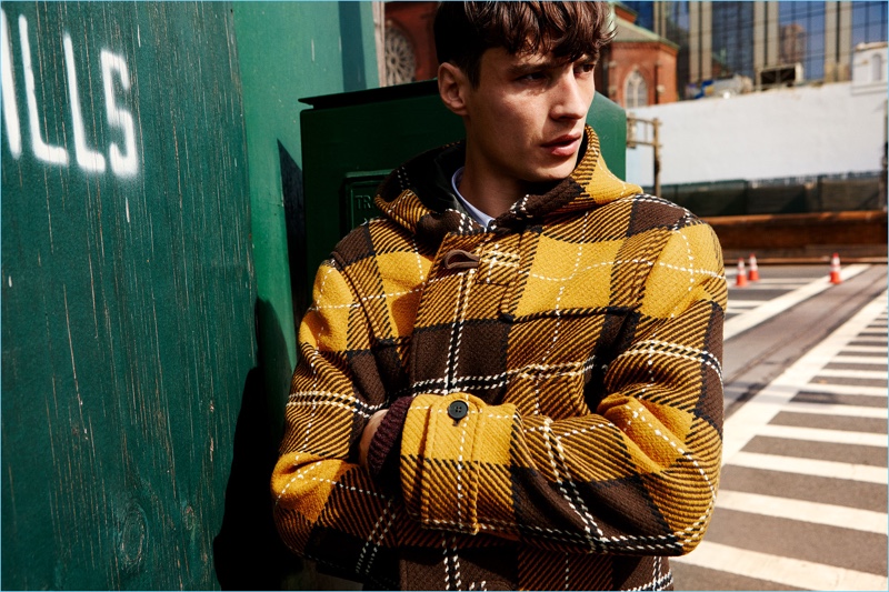 French model Adrien Sahores wears a Zara yellow plaid dufflecoat.