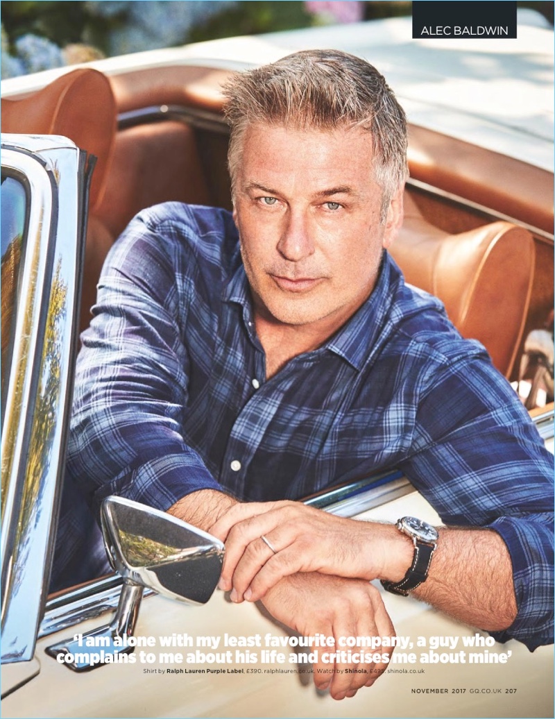 Getting behind the wheel of a vintage convertible, Alec Baldwin wears a Ralph Lauren Purple Label shirt. The actor also dons a Shinola watch.