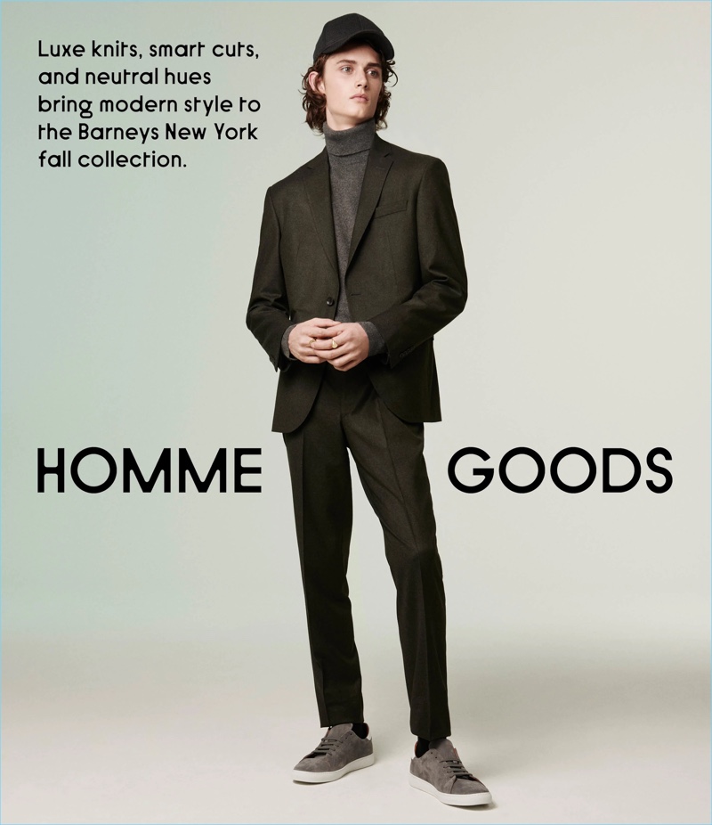 Barneys New York styles its mélange wool suit and suede sneakers with thoughtful pieces. An Officine Generale cashmere turtleneck and Barena Venezia baseball cap add to a smart ensemble.