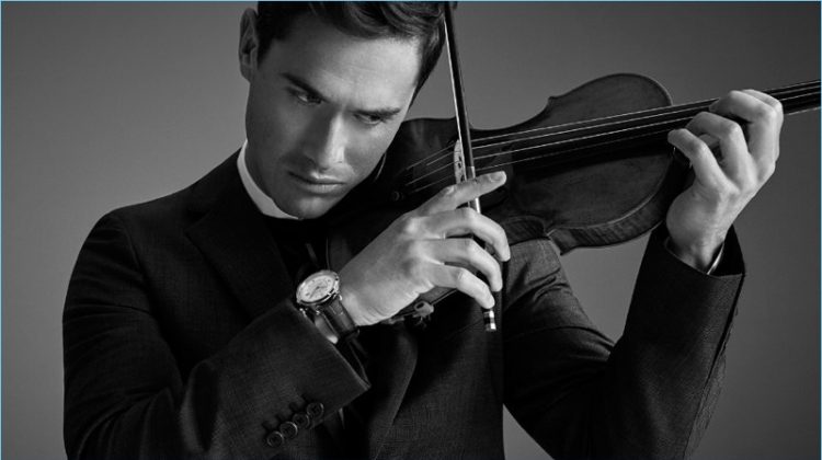 Playing the violin, Charlie Siem wears a Prada wool suit and sweater. He also sports a Jil Sander shirt and Jaeger-LeCoultre watch.
