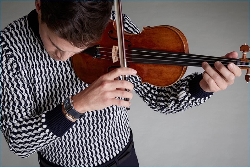 Violinist Charlie Siem sports a Sandro sweater with Dries Van Noten trousers. Siem also wears a Lanvin belt and Jaeger-LeCoultre watch.