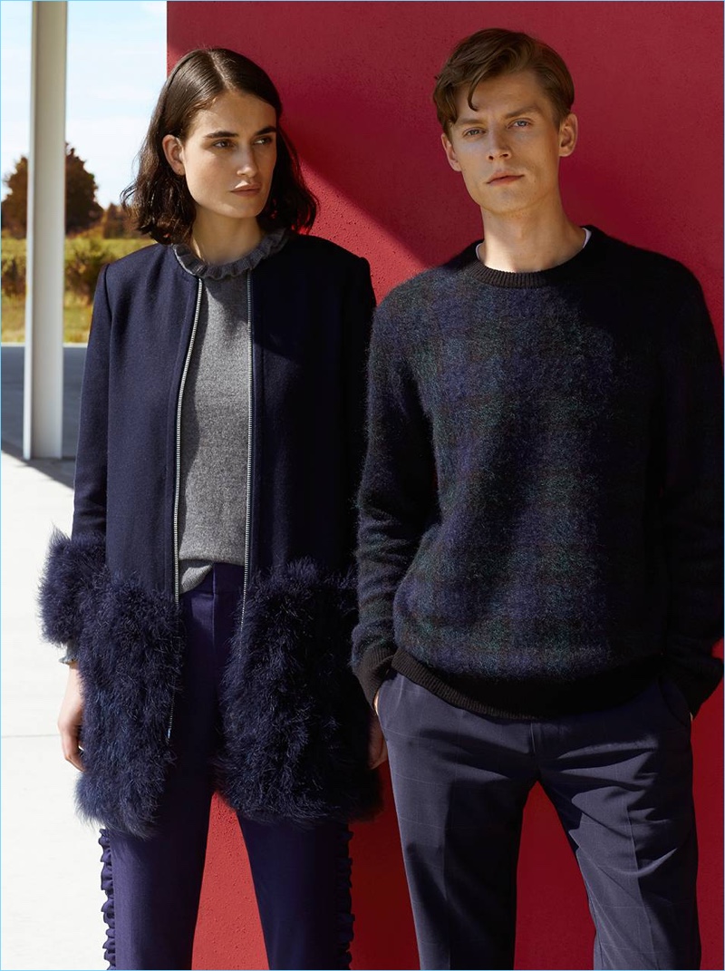 Janis Ancens showcases smart style from Club Monaco. The Latvian model sports a plaid sweater and windowpane trousers.