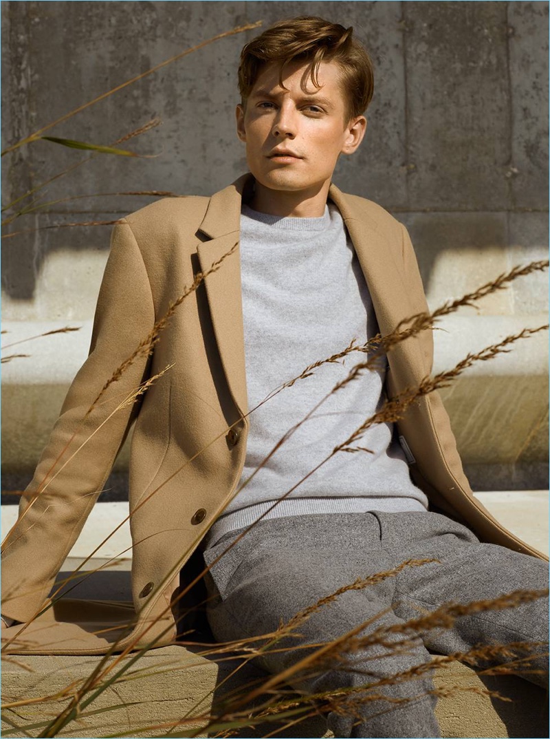 A classic fall vision, Janis Ancens wears a wool topcoat. He also dons Club Monaco's cashmere sweater and wool donegal trousers.
