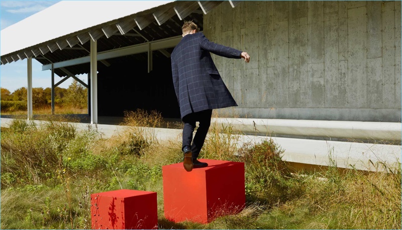 Model Janis Ancens wears a Club Monaco windowpane topcoat and corduroy pants.