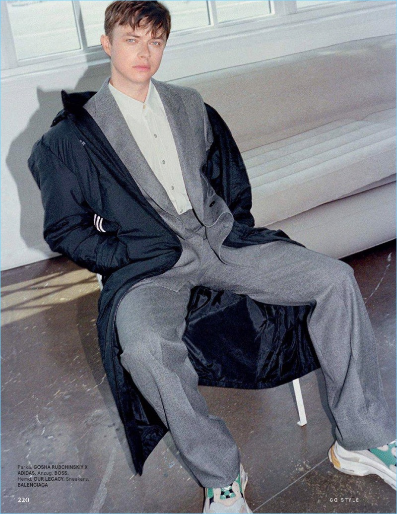 Connecting with GQ Style Germany, Dane DeHaan wears a Gosha Rubchinskiy x Adidas parka. He also sports a BOSS suit with an Our Legacy shirt. Balenciaga sneakers round out DeHaan's look.