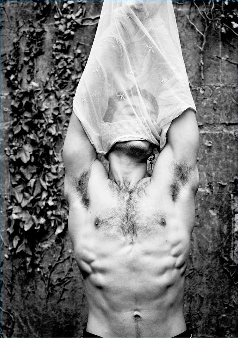 Going shirtless, Ezra Miller appears in a photo by Mikael Jansson.