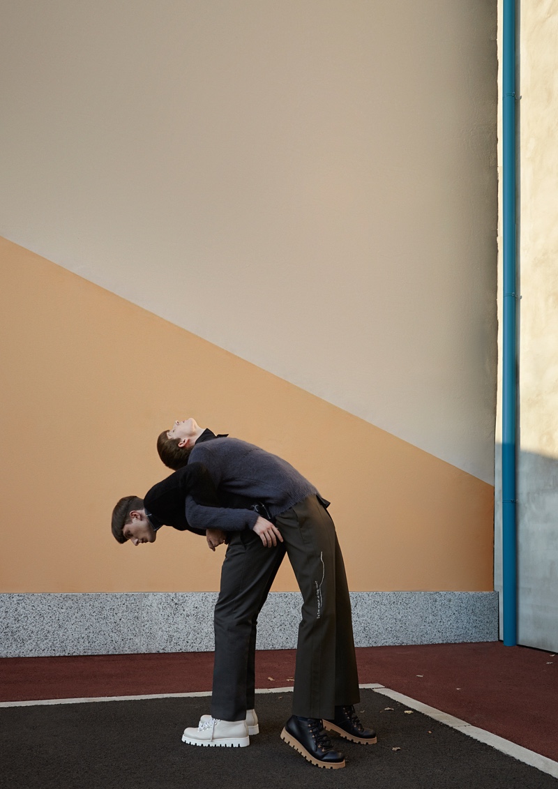 Left to Right: Gabriel Demaj wears a Federico Curradi sweater and trousers. A Diesel shirt and Ermenegildo Zegna shoes complete his look. Andre Fernandes dons a Federico Curradi sweater and trousers. He also models a Frankie Morello shirt and Ermenegildo Zegna shoes.