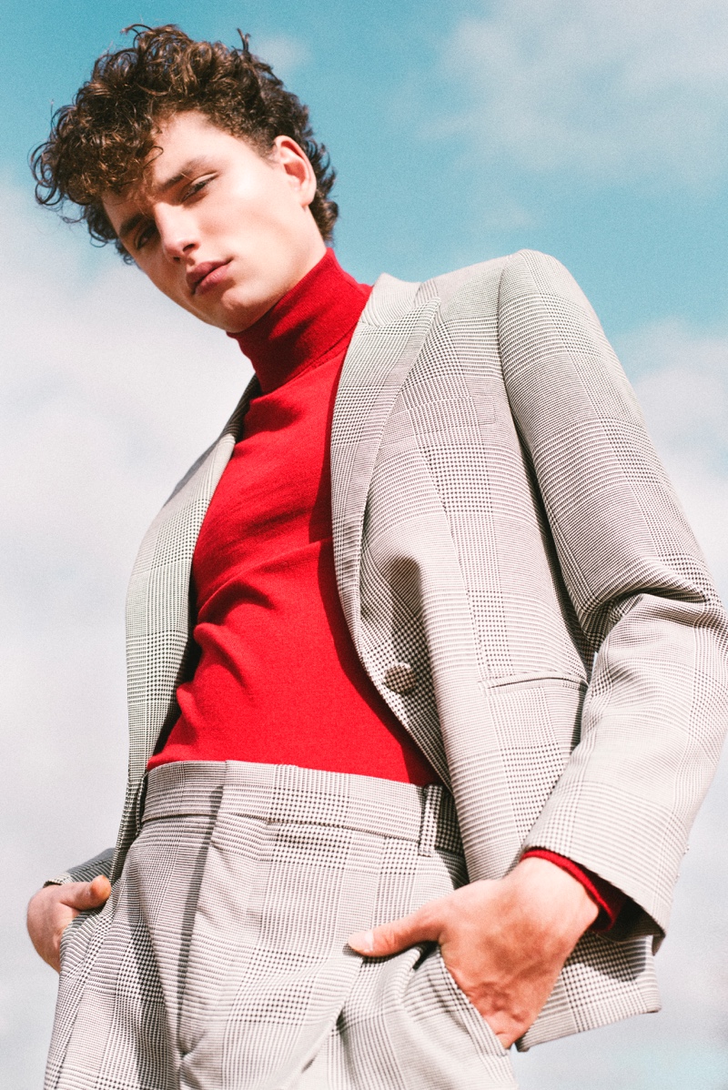 Making a chic statement, Steve Sarkozy wears a red turtleneck with a sharp suit.