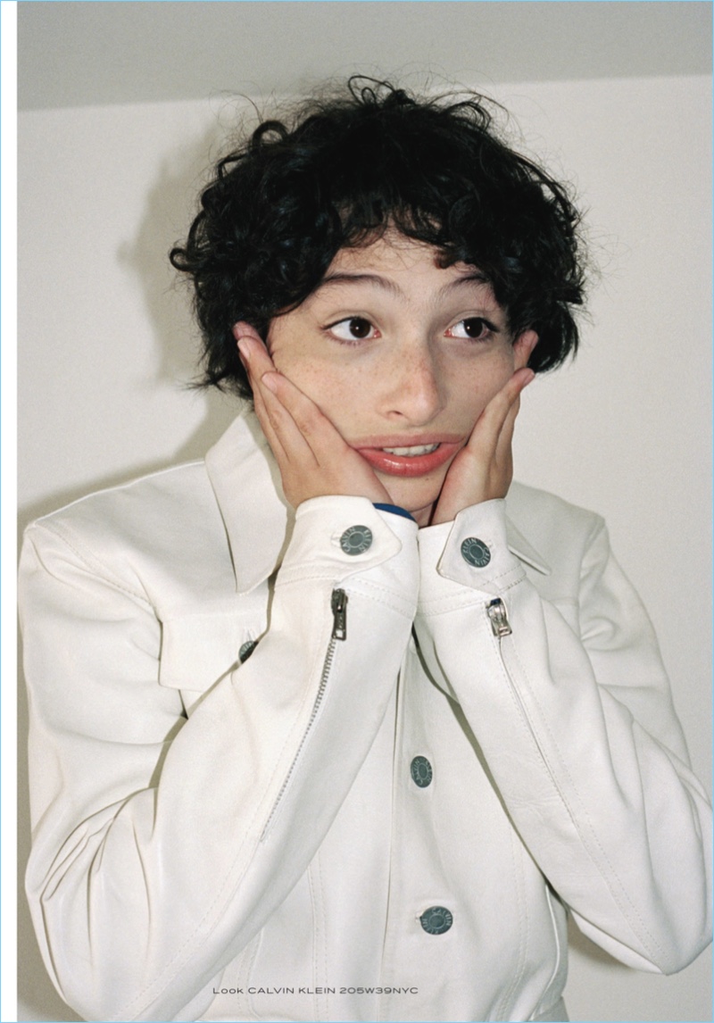 Actor Finn Wolfhard sports a white jacket by Calvin Klein.