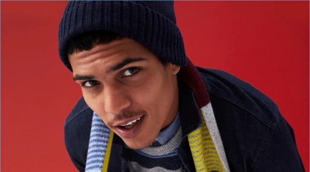 Gap proposes colorful stripes. Here, Geron McKinley models a stripe sweater with a chambray shirt. He also wears a striped scarf, denim jacket, and skinny-fit jeans.