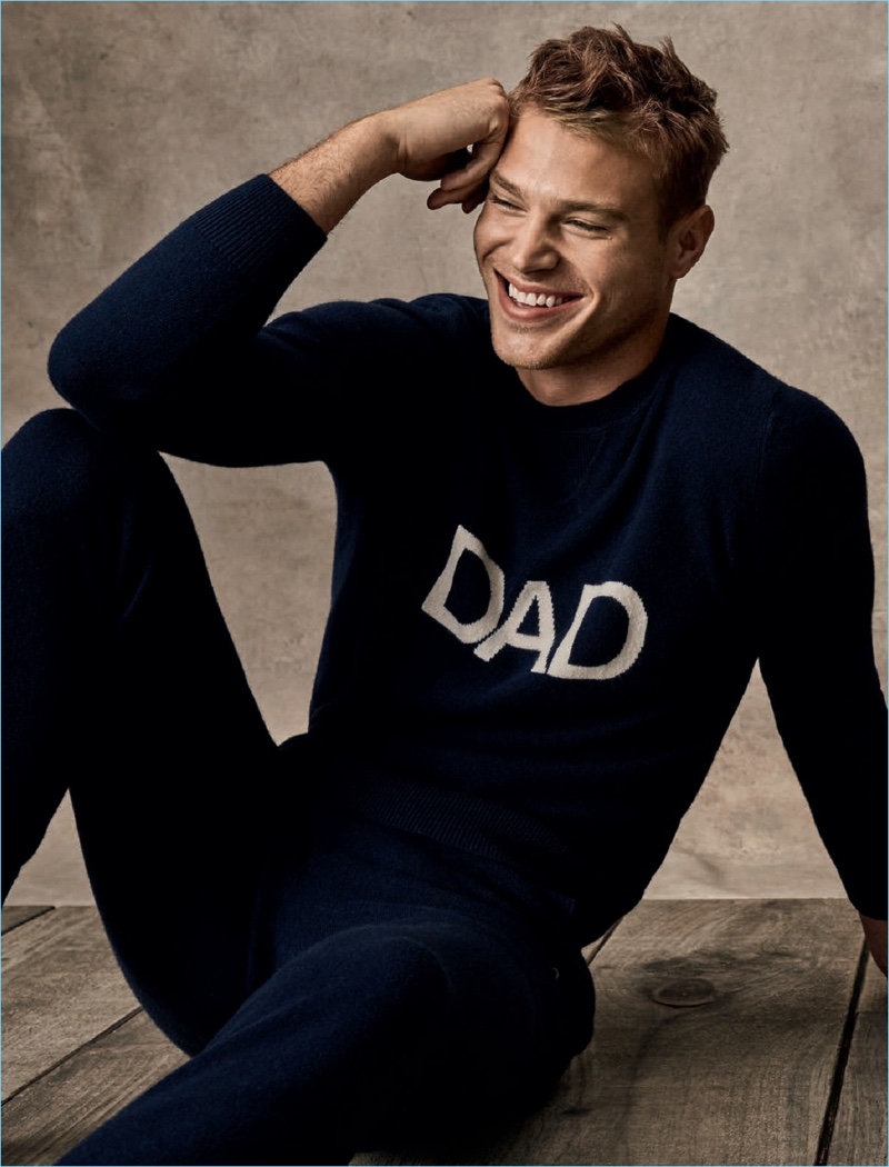 Wearing a "Dad" sweater by Ron Dorff, Matthew Noszka is all smiles.