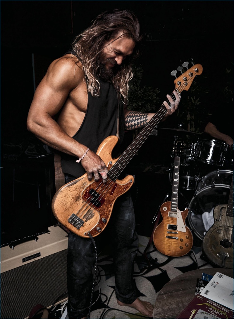 Playing the guitar, Jason Momoa stars in a new photo shoot.