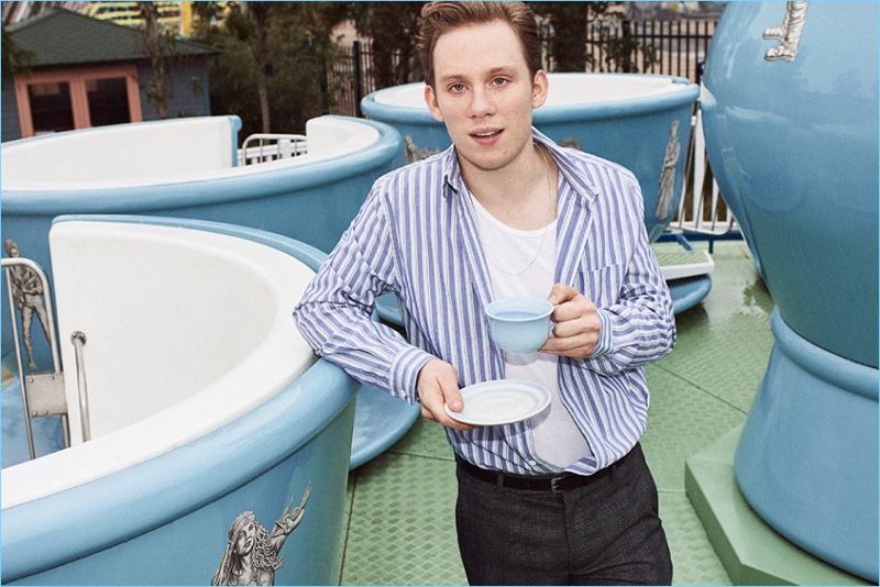 Enjoying a cup of tea, Joe Cole wears an Acne Studios striped oxford shirt and Sunspel tank. He also sports Maison Margiela checked trousers and a Lanvin leather belt.