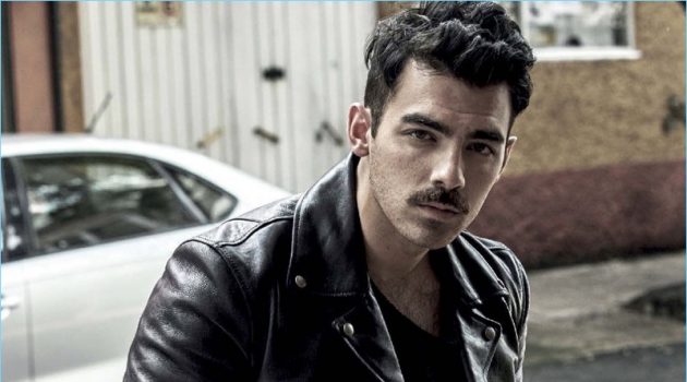Joe Jonas Rocks Mustache for Vogue Hombre Cover Shoot A cool vision, Joe Jonas rocks a Salvatore Ferragamo leather jacket. The singer also dons a sweater and pants by GUESS.