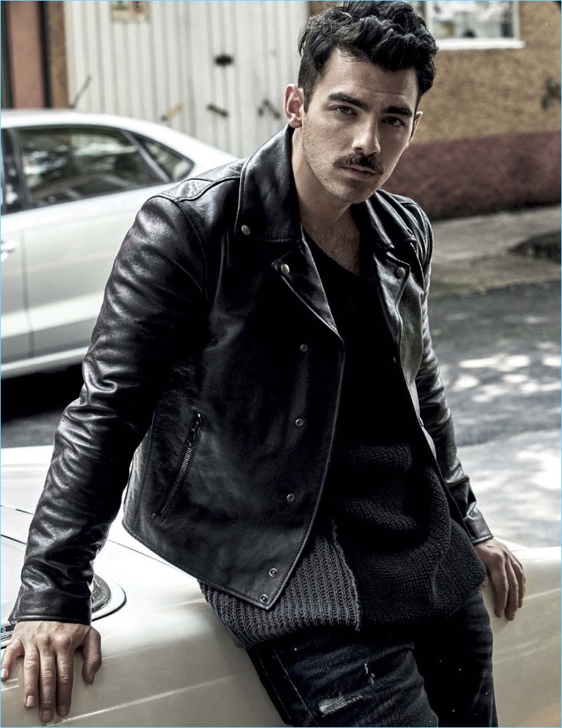 A cool vision, Joe Jonas rocks a Salvatore Ferragamo leather jacket. The singer also dons a sweater and pants by GUESS.