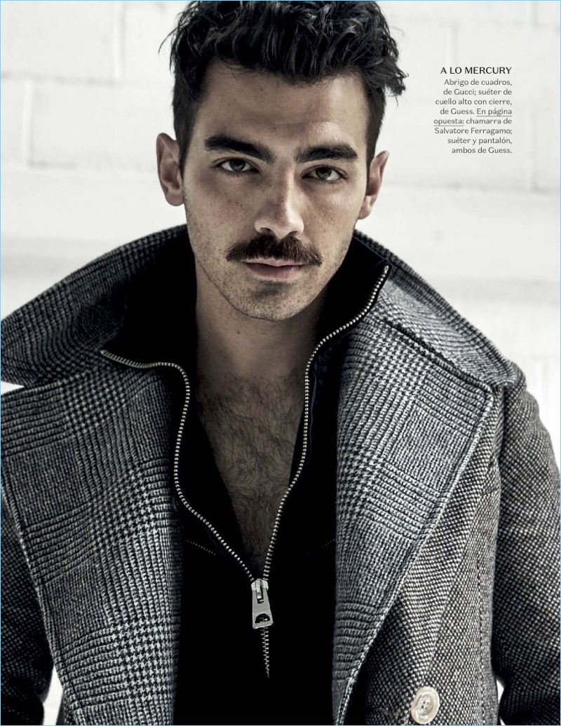 Rocking a mustache, Joe Jonas wears a Gucci coat with a Guess sweater.