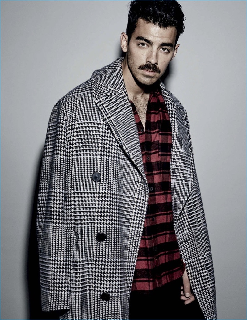 DNCE frontman Joe Jonas wears a Hermès coat with a H&M shirt and GUESS pants.