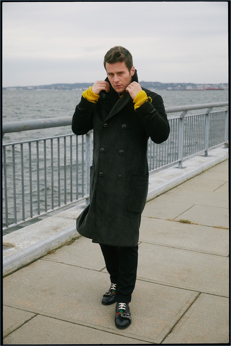 Taking a stroll, Jonathan Groff wears a vintage shirt with a Gucci sweater. Groff also dons a Todd Snyder coat, Calvin Klein jeans, and Gucci sneakers.