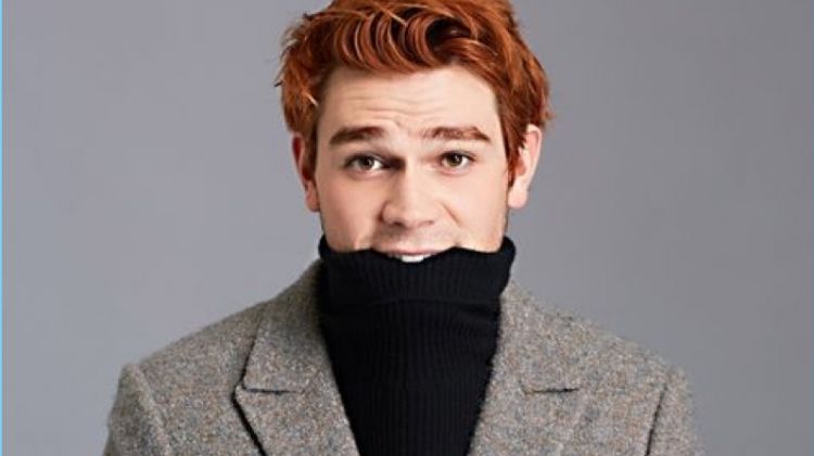 Pouring on the charm, KJ Apa wears a Theory turtleneck sweater with an Ermenegildo Zegna Couture suit jacket and Tommy Hilfiger trousers.