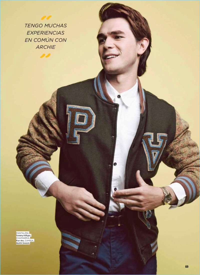 Going preppy, KJ Apa sports a Pan-Am varsity jacket with an Austin Season shirt and Tommy Hilfiger pants.