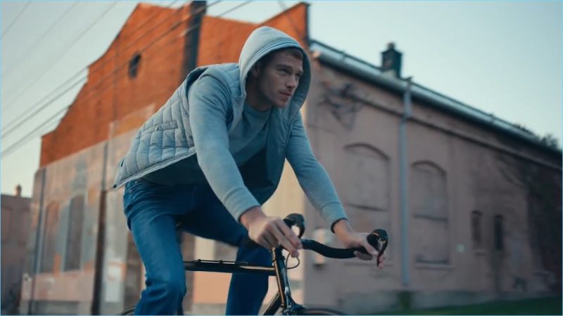 American model Matthew Noszka rides a bike in Express' Tough denim jeans.