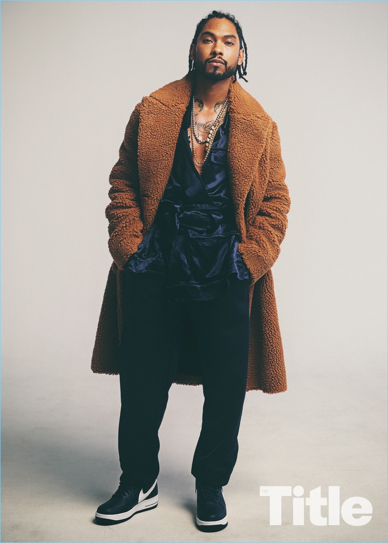 Singer Miguel wears a Stella McCartney coat with a Vivienne Westwood jacket.