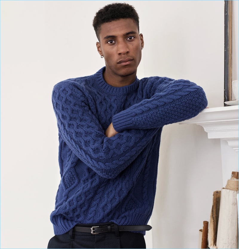 Joshua Payne sports a Mr P. cable-knit sweater and navy wool trousers.