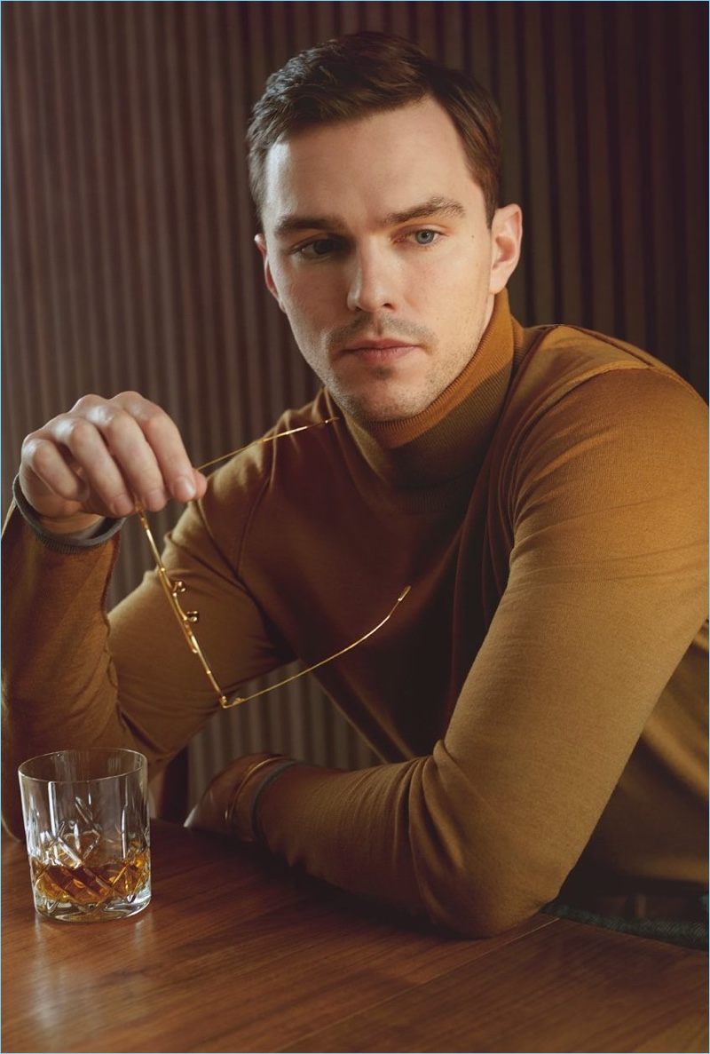 A sleek vision, Nicholas Hoult wears a Maison Margiela turtleneck sweater and Bottega Veneta glasses.