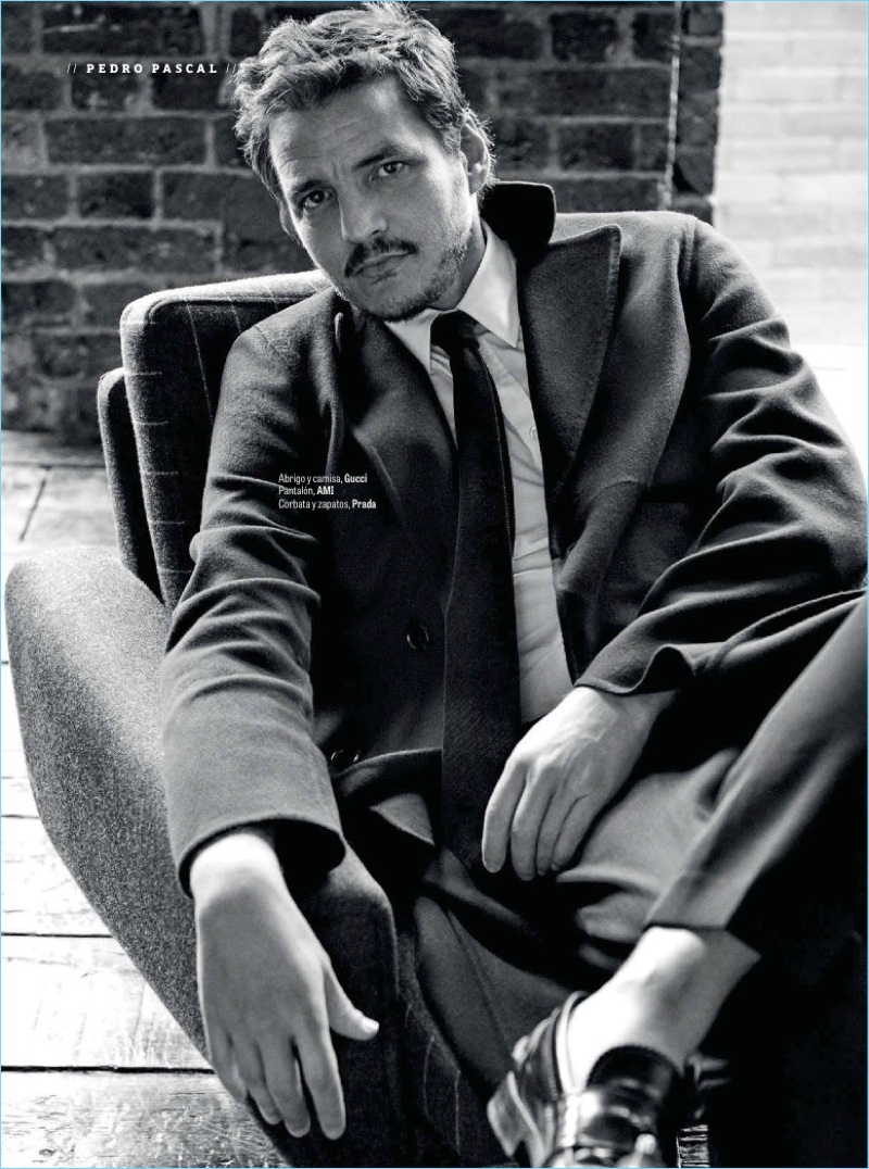 Connecting with GQ México, Pedro Pascal wears a shirt and coat by Gucci. He also sports AMI pants with a tie and shoes by Prada.