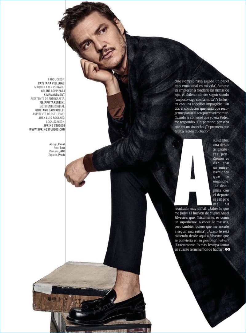 Charming to say the least, Pedro Pascal dons a Canali coat. Pascal also wears a BOSS polo, AMI pants, and Prada shoes.