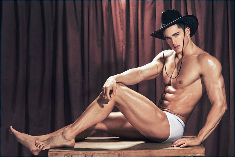 Model Pietro Boselli wears a western-style hat for a BENCH/ Body underwear photo shoot.