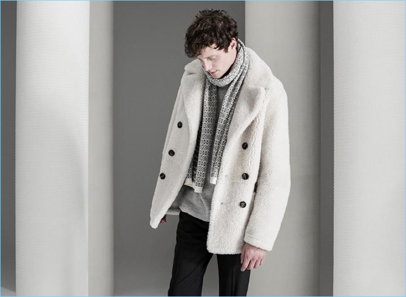 English model Matthew Hitt dons a Theory reversible shearling jacket and cashmere fair isle scarf. The leading model also wears Theory’s cashmere ribbed sweater and stretch wool pants.