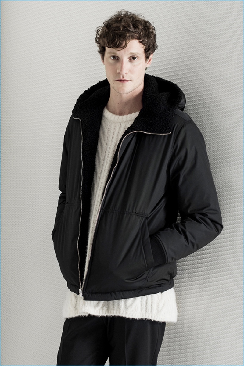 Matthew Hit sports a Theory cable-knit sweater and sherpa-lined jacket. He also wears Theory’s stretch wool pants.